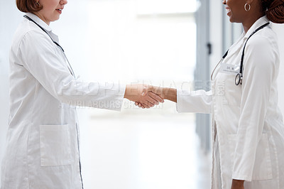 Buy stock photo Female doctor and nurse, shaking hands for partnership, agreement and thank you for assistance. Happy, healthcare workers and handshake for teamwork, trust and support together in hospital or lab