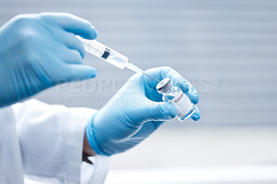 Buy stock photo Shot of a doctor preparing a dose of the covid vaccination for a patient