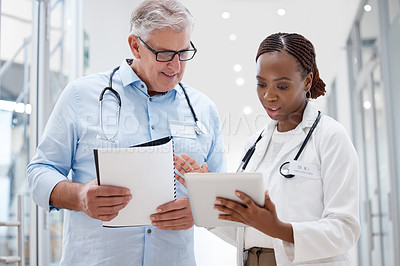 Buy stock photo Shot of two doctors discussing a patients results