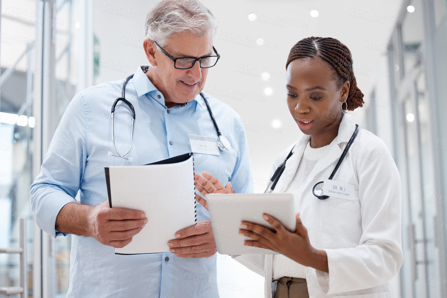 Buy stock photo Shot of two doctors discussing a patients results