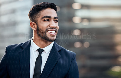 Buy stock photo Shot of a handsome young businessman standing alone outside