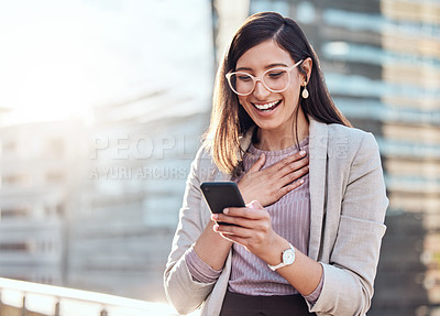 Buy stock photo Shot of an attractive young businesswoman standing alone outside and looking surprised while using her cellphone