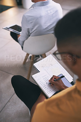 Buy stock photo Shot of an unrecognizable businessperson writing in a notebook during a conference at work