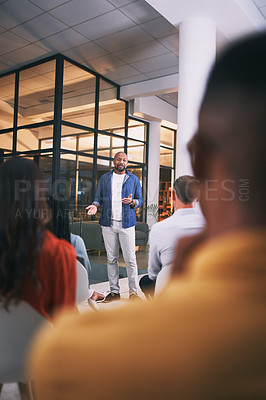 Buy stock photo Shot of a young businessman talking during a conference at work