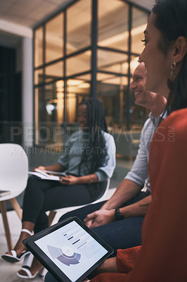 Buy stock photo Shot of a young woman using a tablet during a team meeting