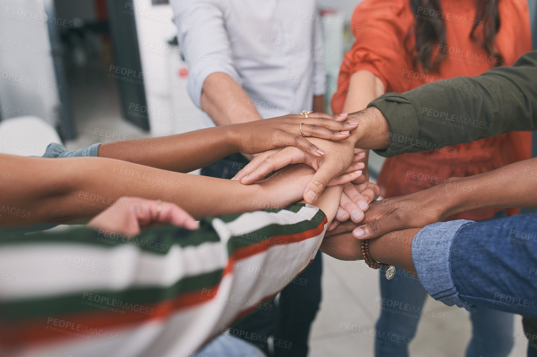 Buy stock photo Shot of a unrecognizable team of business people stacking their hands in motivation