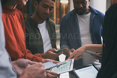 Buy stock photo Shot of a  team of colleagues using digital tablets and