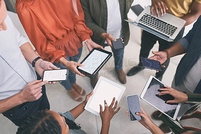 Buy stock photo Shot of a unrecognizable  team of colleagues using digital tablets and