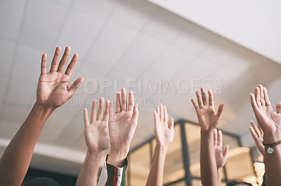 Buy stock photo Shot of a group of business people with their hands raised