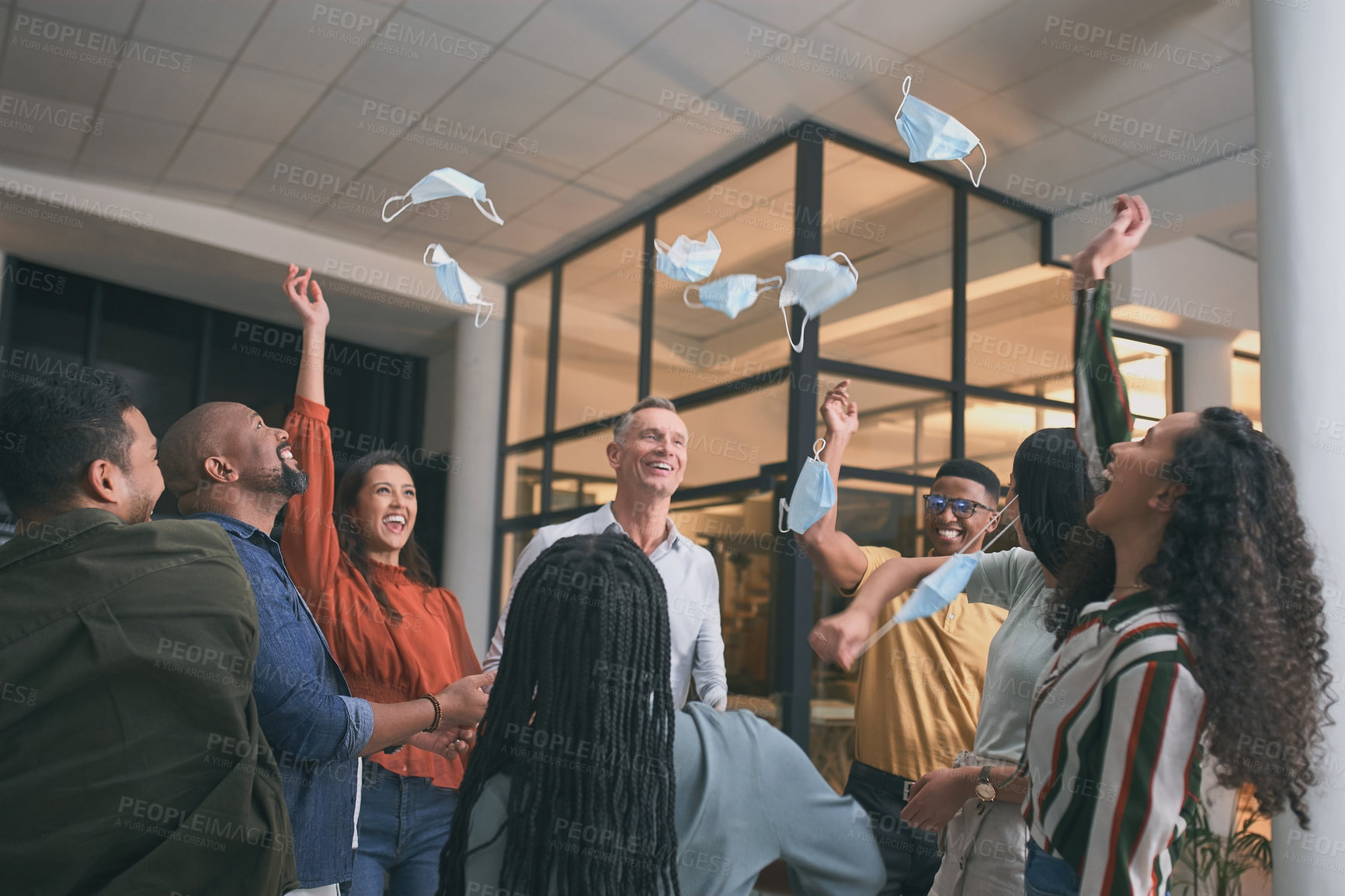 Buy stock photo Shot of a group of businesspeople removing their face masks and tossing them into the air
