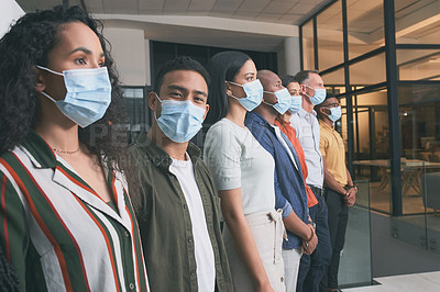 Buy stock photo Shot of a team of coworkers in their office during lockdown