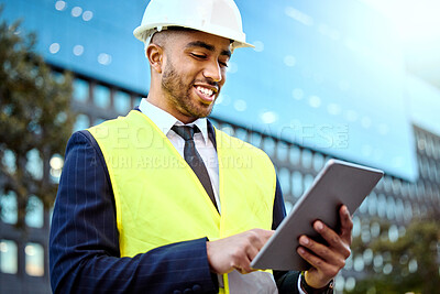Buy stock photo Shot of a young businessman on a construction site using a digital tablet
