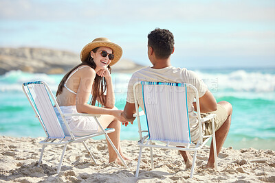 Buy stock photo Shot of a young couple relaxing at the beach