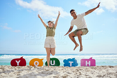Buy stock photo Shot of a young couple enjoying a day at the beach