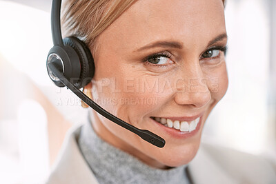 Buy stock photo Cropped portrait of an attractive mature female call center agent wearing a headset while working in her office
