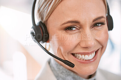 Buy stock photo Cropped portrait of an attractive mature female call center agent wearing a headset while working in her office