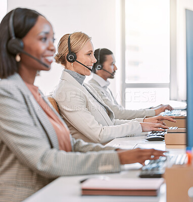 Buy stock photo Cropped shot of an attractive mature female call center agent wearing a headset while working in the office with her coworkers