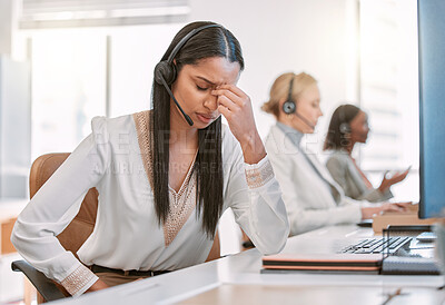 Buy stock photo Cropped shot of an attractive young female call center agent suffering with a headache while working on her computer in the office