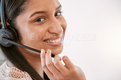 Buy stock photo Cropped portrait of an attractive young female call center agent wearing a headset while working in the office