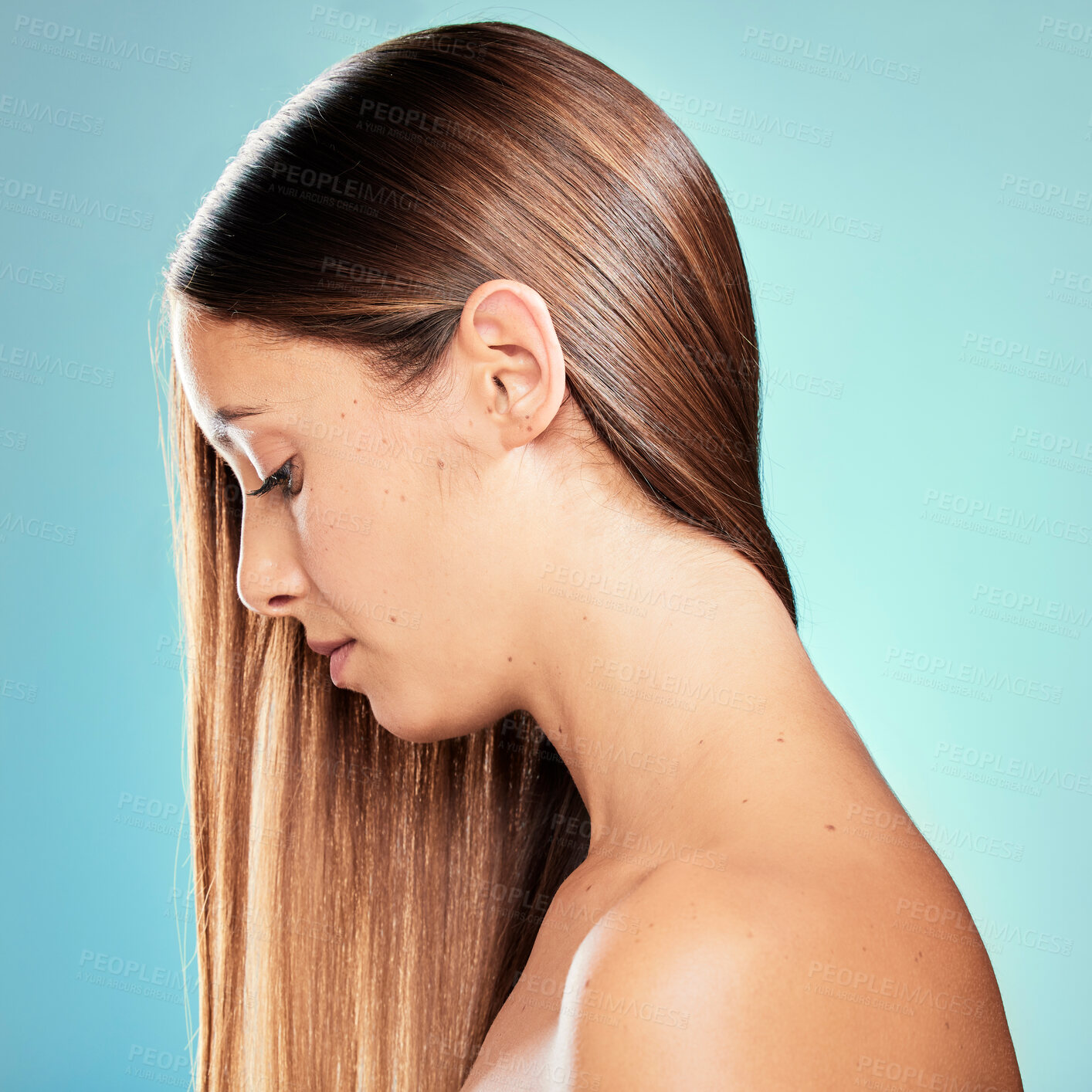 Buy stock photo Studio shot of an attractive young woman posing against a blue background