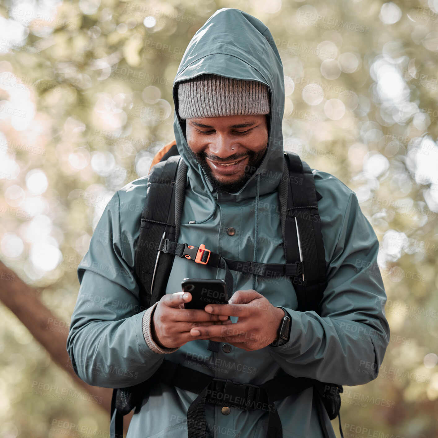 Buy stock photo Black man, phone and smile for hiking communication, social media or chat in nature outdoors. Happy African male person or hiker smiling on mobile smartphone for trekking, travel or online location