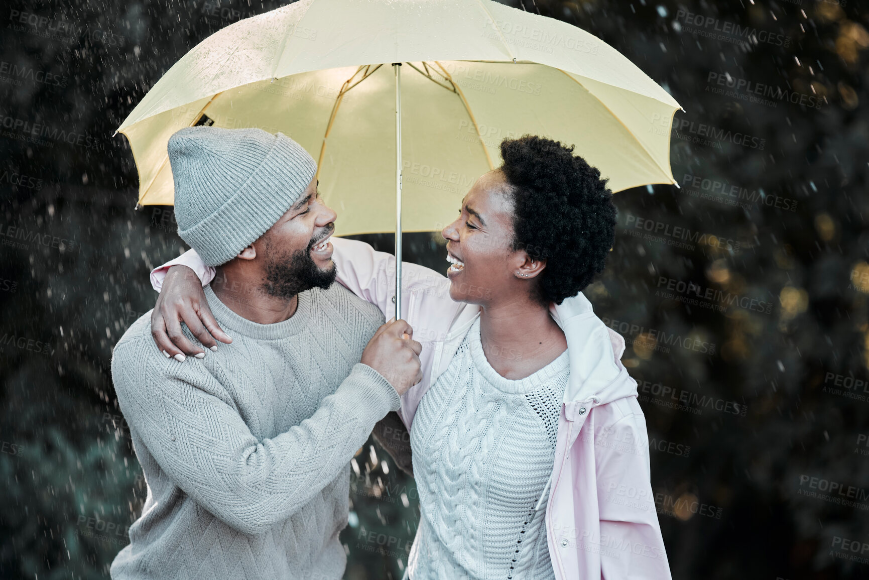 Buy stock photo Black couple, umbrella and hug in outdoor rain, love and speaking on winter date in nature. People, talking and affection in marriage for security or insurance, together and romance in countryside