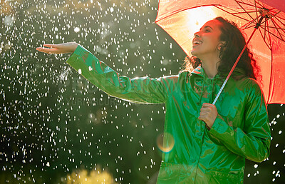 Buy stock photo Shot of a beautiful young woman having fun in the rain