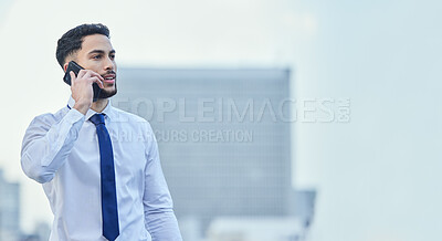 Buy stock photo Cropped shot of a handsome young businessman making a phonecall while standing outside in the city