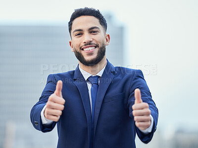 Buy stock photo Cropped portrait of a handsome young businessman giving thumbs up while standing outside in the city