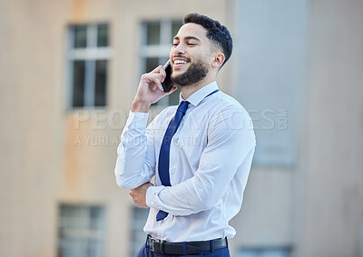 Buy stock photo Cropped shot of a handsome young businessman making a phonecall while standing outside in the city