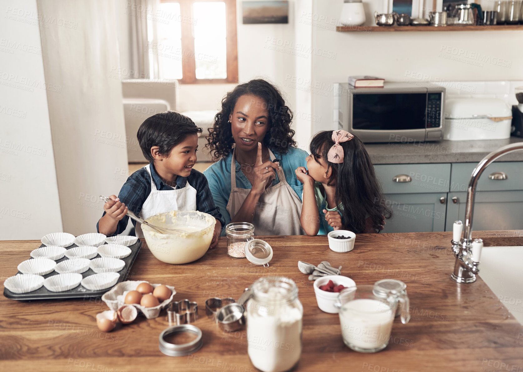 Buy stock photo Shot of a woman baking at home with her children