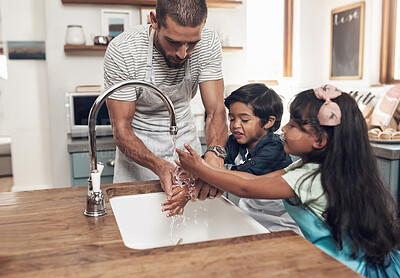 Buy stock photo Shot of a man and his two children washing their hands in the kitchen basin