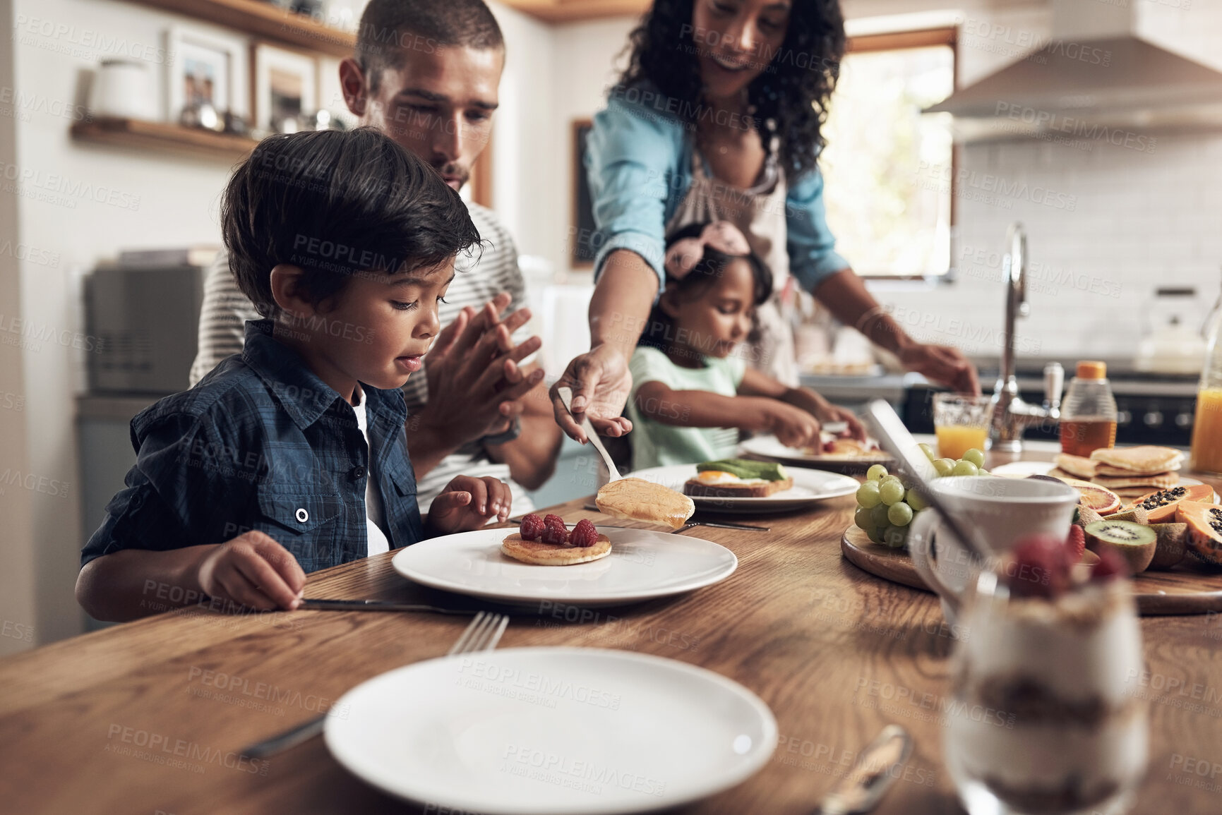 Buy stock photo Kitchen table, father and mother with children for breakfast, food and nutrition in morning as family. Home, girl and boy with parents for serving pancakes, eating and bonding together with meal