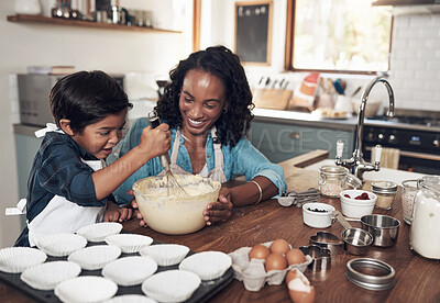 Buy stock photo Shot of a woman baking at home with her young son