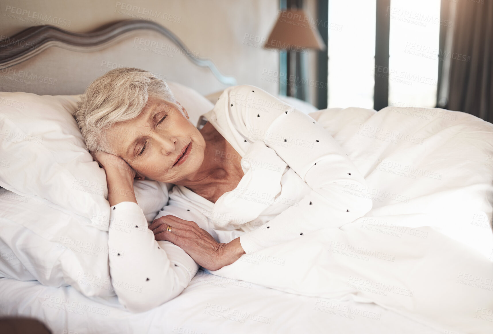 Buy stock photo Shot of a senior woman sleeping in bed in a nursing home