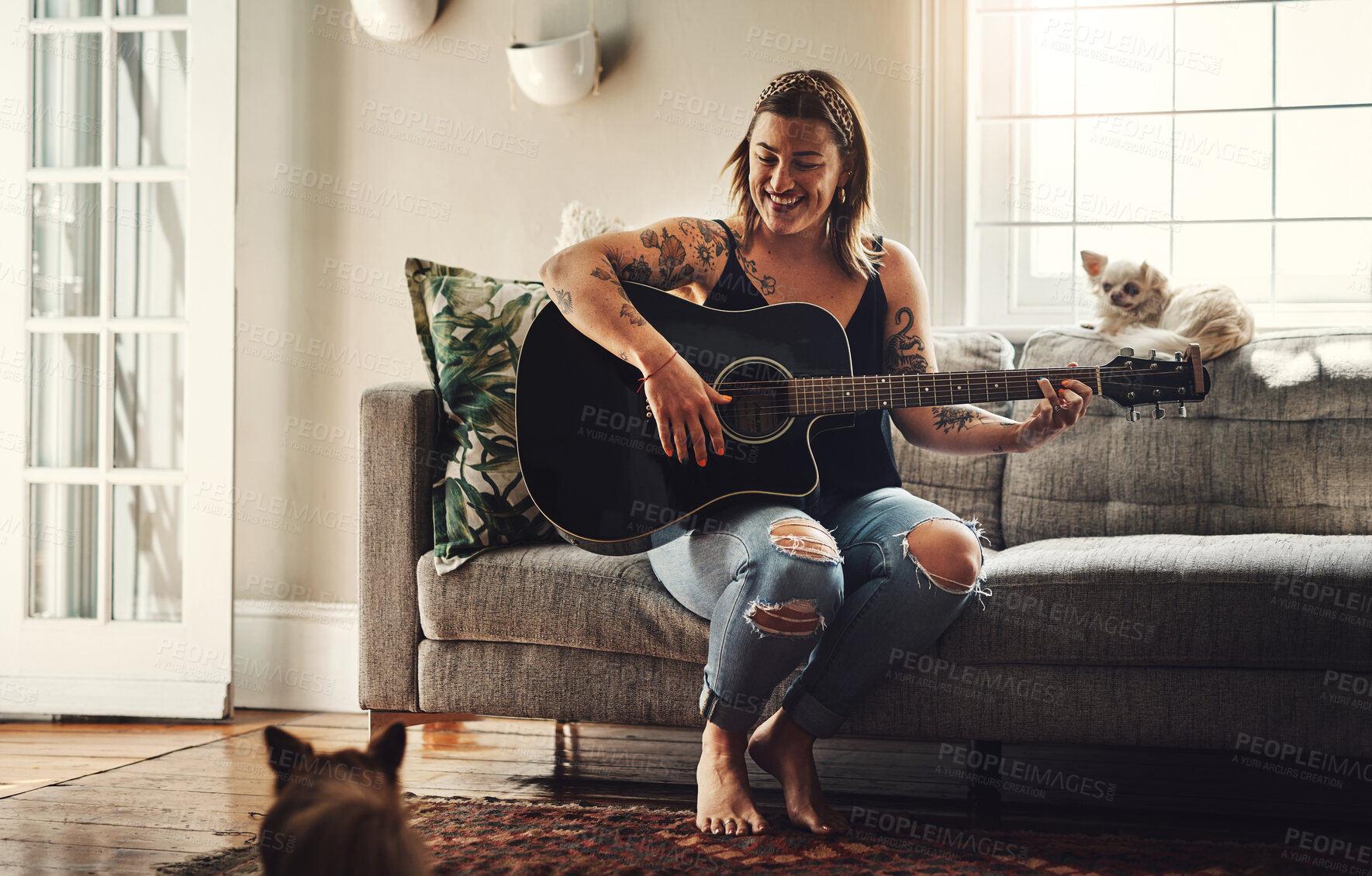 Buy stock photo Woman, home and happy with guitar on couch in living room for rehearsal, practice and song writing. Female person, musician and instrument on sofa in lounge at apartment with hobby, skill and talent