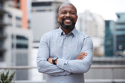 Buy stock photo Portrait of a confident mature businessman standing with his arms crossed on a balcony outside an office
