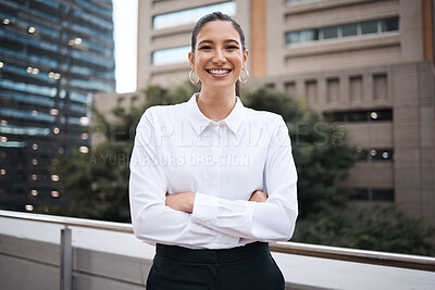 Buy stock photo Portrait of a confident young businesswoman standing with her arms crossed on a balcony outside an office