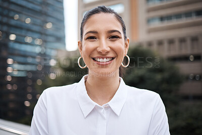 Buy stock photo Portrait of a confident young businesswoman standing on a balcony outside an office