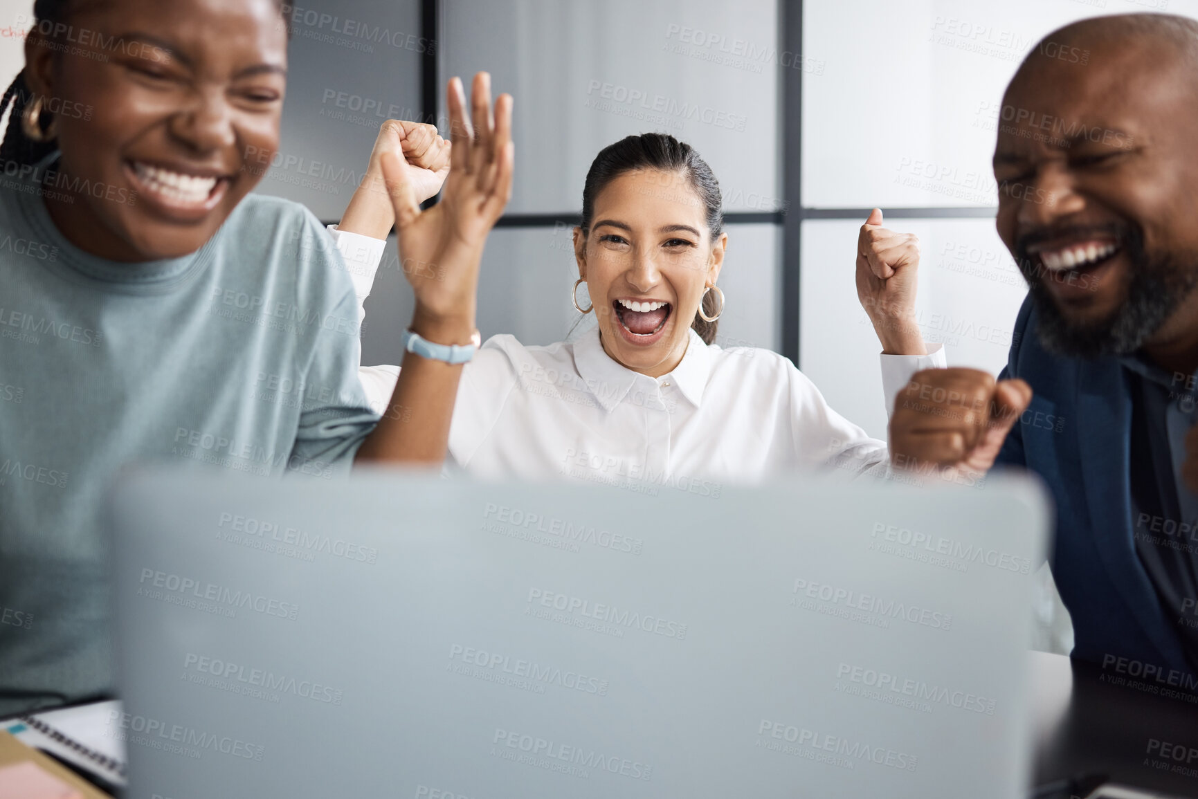 Buy stock photo Shot of a group of businesspeople cheering while using a laptop together in an office