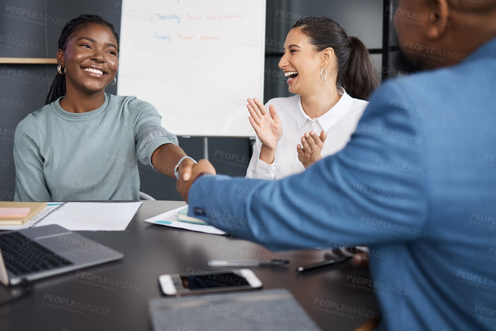 Buy stock photo Shot of businesspeople shaking hands during a meeting in an office