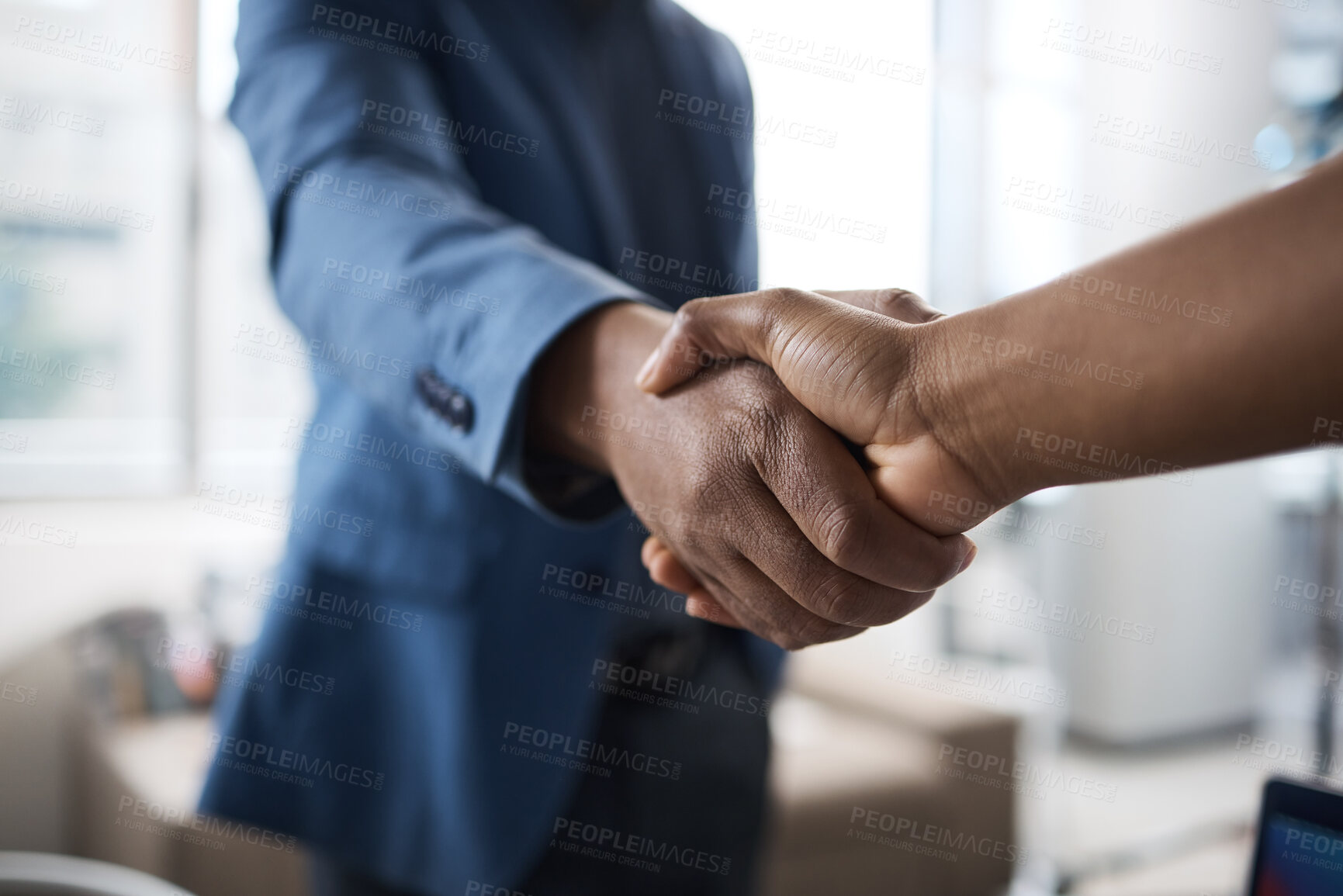 Buy stock photo Closeup shot of two unrecognisable businesspeople shaking hands in an office