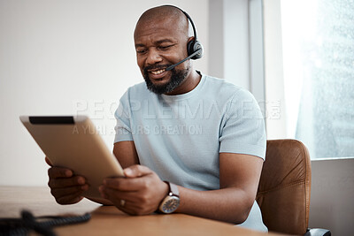 Buy stock photo Shot of a man using a digital tablet while working in a call center