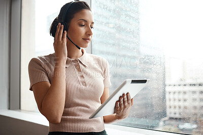 Buy stock photo Shot of a woman using a digital tablet while working in a call center