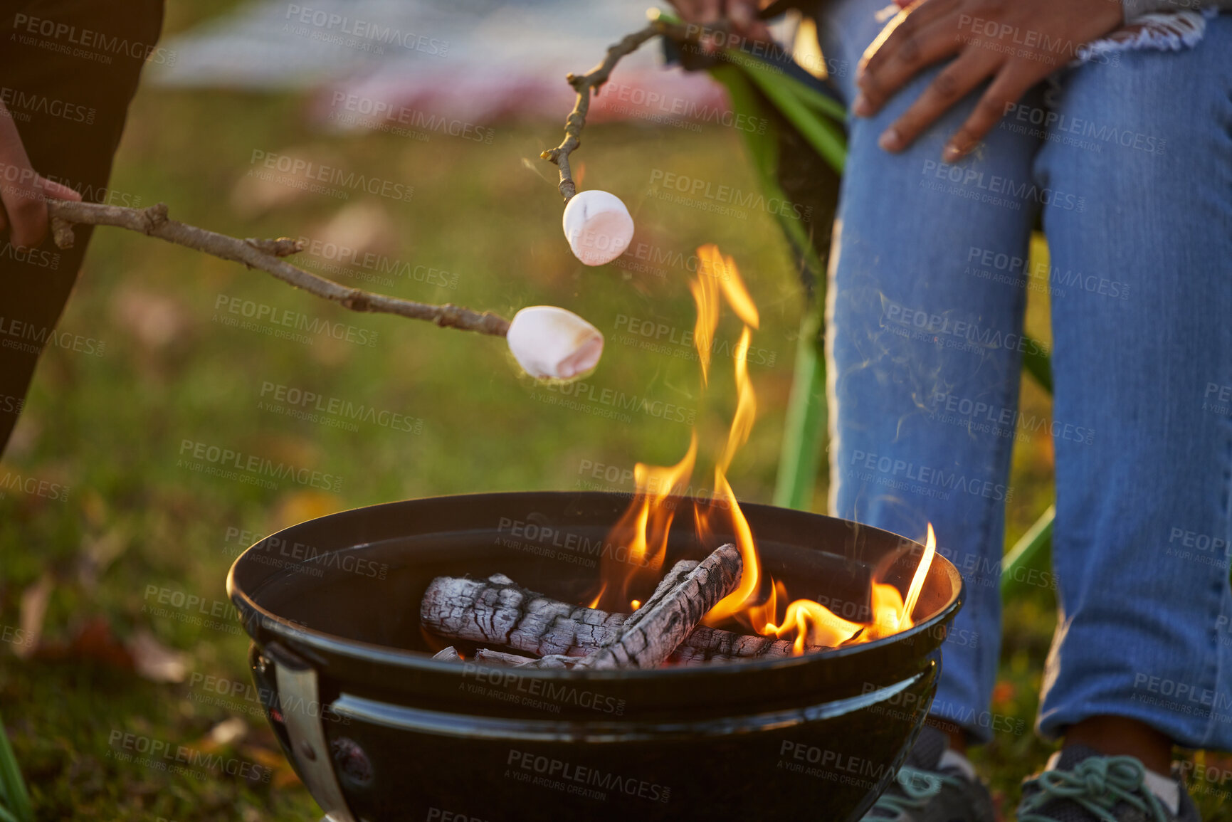 Buy stock photo People, toasting and marshmallow by fire on camping in forest with love or bonding for adventure. Man, woman and smores with grill for dessert by flame in nature on vacation for memories on picnic