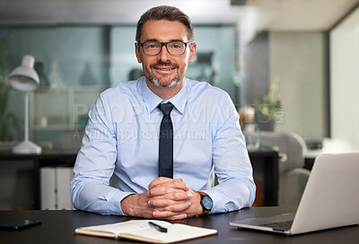 Buy stock photo Cropped portrait of a handsome mature businessman working at his desk in the office