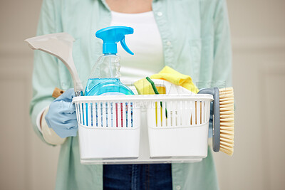 Buy stock photo Shot of a woman holding a basket of cleaning products