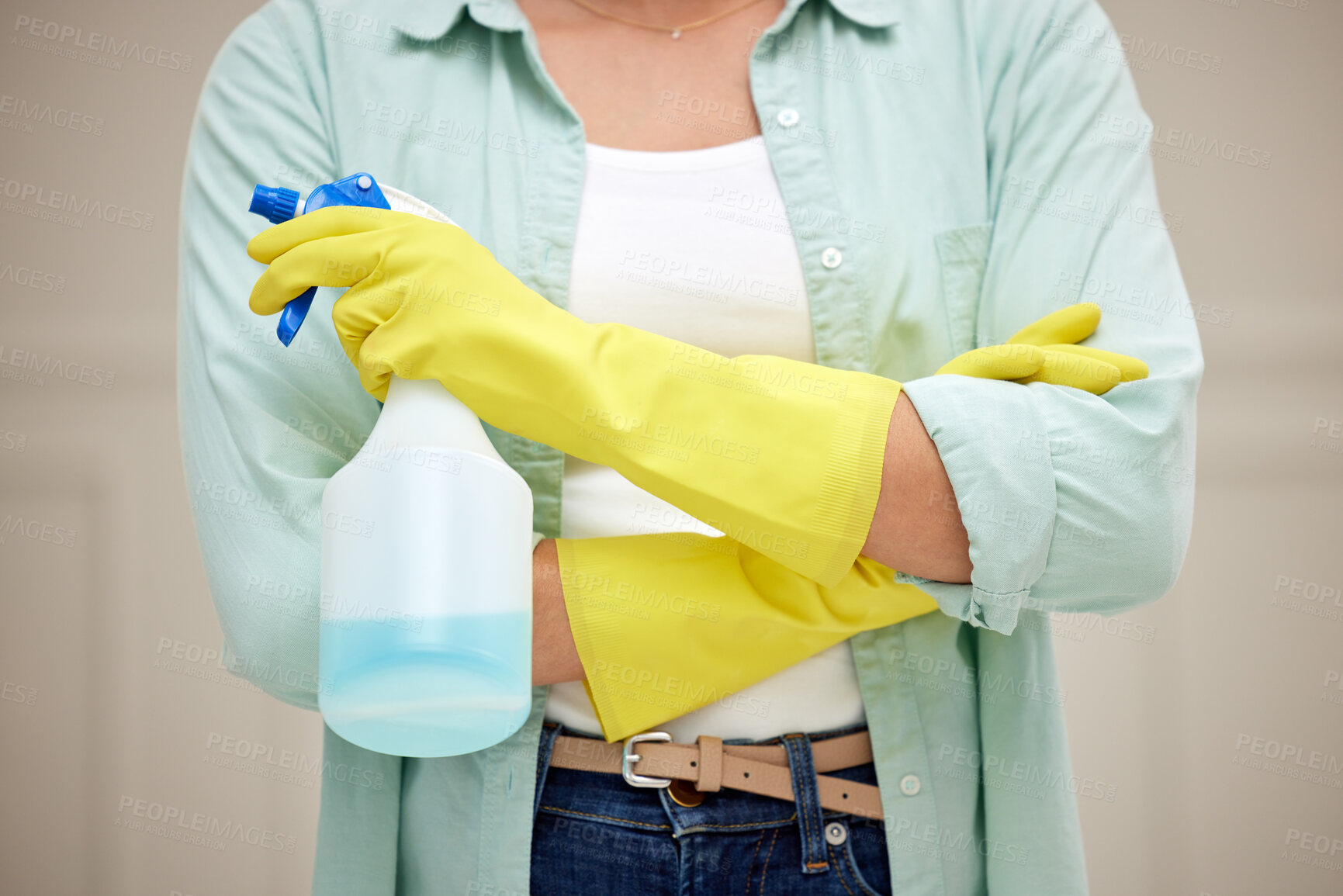 Buy stock photo Shot of a woman holding a spray bottle about to clean