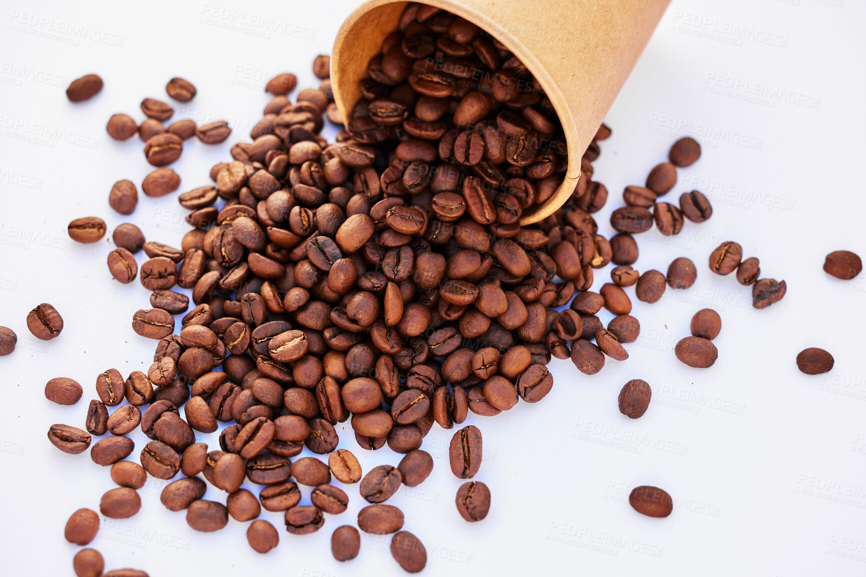 Buy stock photo Coffee beans, top view and table closeup in studio isolated on a white background or backdrop. Above, caffeine and roast grain in cup for natural breakfast, organic latte or espresso in the morning