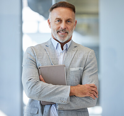 Buy stock photo Portrait of a mature businessman holding a digital tablet while standing in an office
